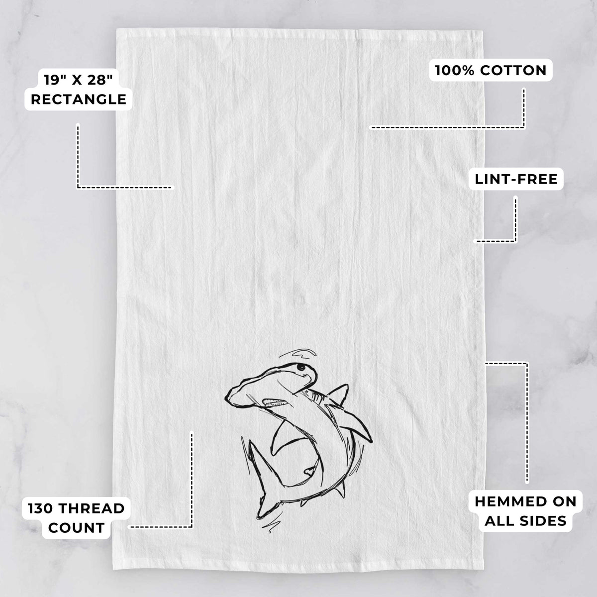White tea towel printed with a black ink illustration of a hammerhead shark swimming in a curve, with feature labels: 19 by 28 inch rectangle, 100% cotton, lint-free, 130 thread count, hemmed on all sides.