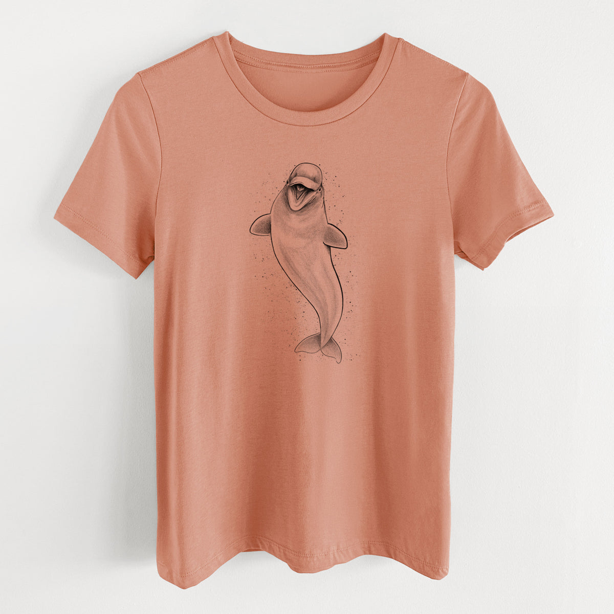 Terracotta orange women's relaxed fit cotton t-shirt laid flat, printed with a black ink illustration of a smiling beluga whale swimming upward.
