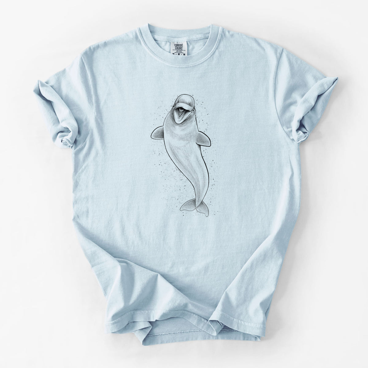 Chambray blue Comfort Colors t-shirt laid flat, printed with a black ink illustration of a smiling beluga whale swimming upward.