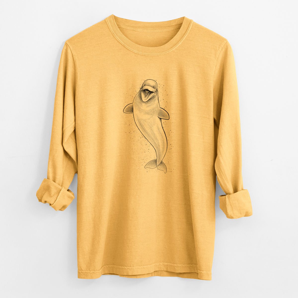 Golden wheat yellow Comfort Colors long sleeve shirt laid flat with the cuffs rolled, printed with a black ink illustration of a smiling beluga whale swimming upward.