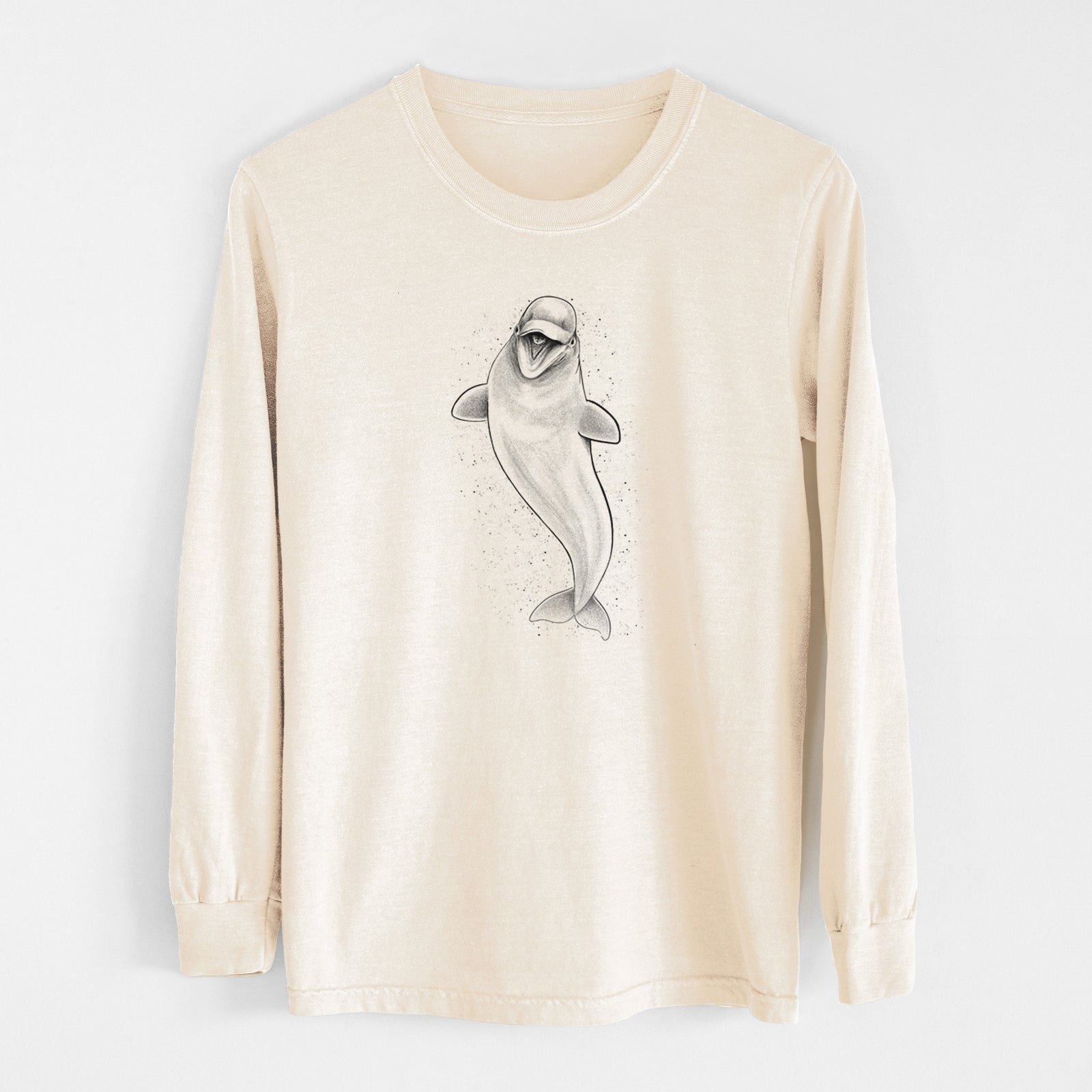 Ivory Comfort Colors long sleeve shirt laid flat, printed with a black ink illustration of a smiling beluga whale swimming upward.
