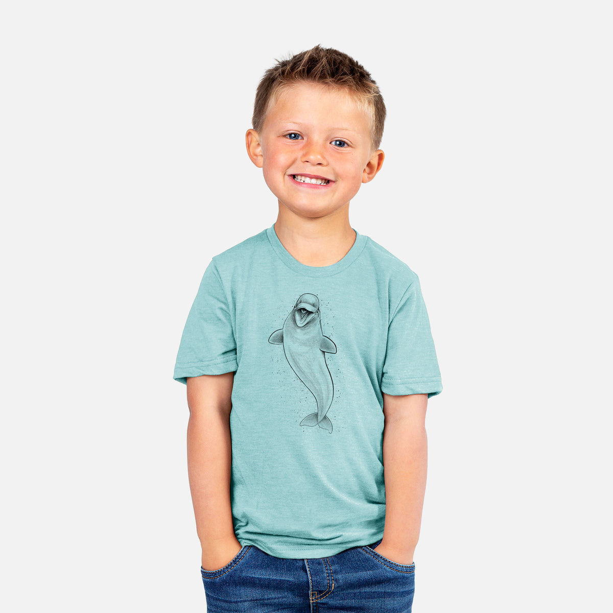 Smiling boy wearing a youth t-shirt printed with a black ink illustration of a smiling beluga whale swimming upward.