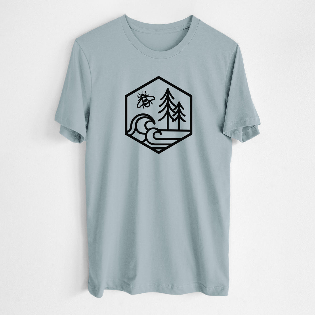 Vintage denim lightweight cotton t-shirt laid flat, printed with a black line art hexagon holding a bee, ocean waves and pine trees.