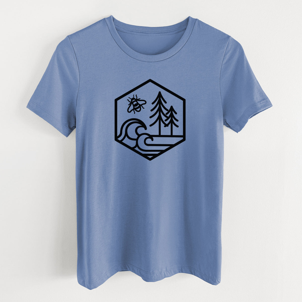 Blue bell women's relaxed fit cotton t-shirt laid flat, printed with a black line art hexagon holding a bee, ocean waves and pine trees.