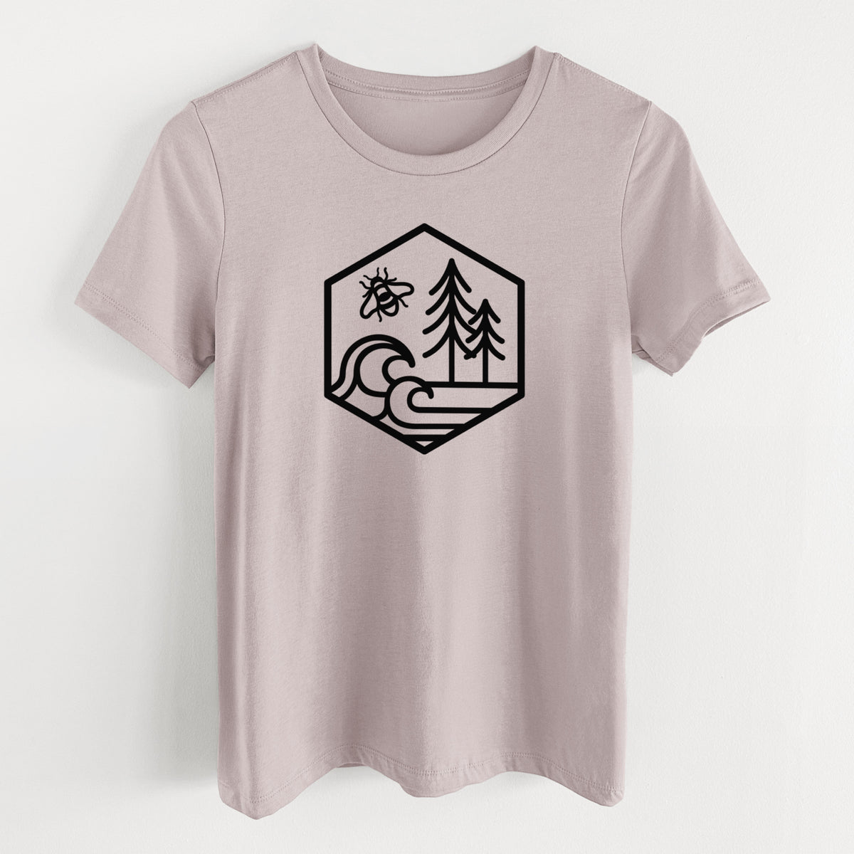 Pink gravel women's relaxed fit cotton t-shirt laid flat, printed with a black line art hexagon holding a bee, ocean waves and pine trees.
