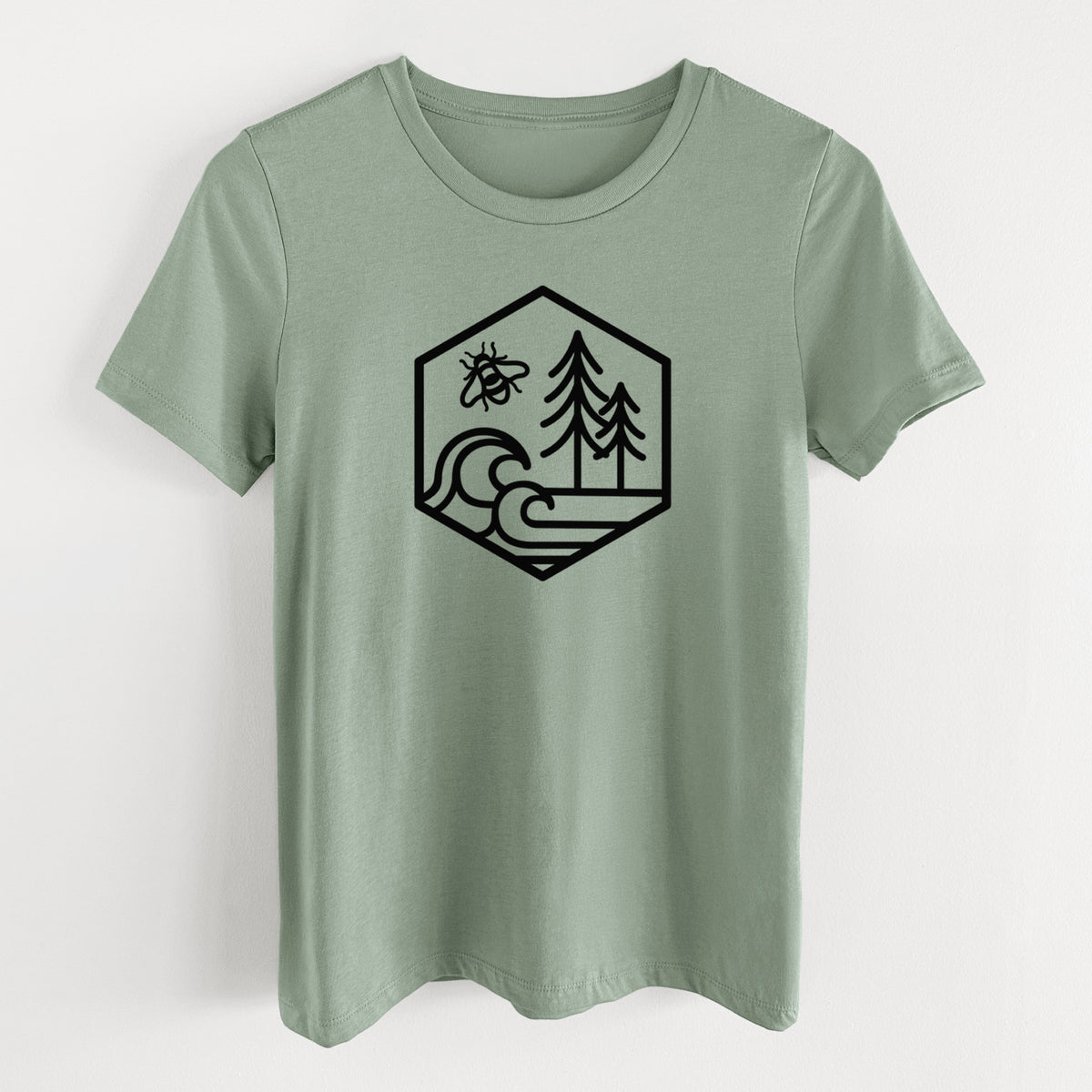 Sage green women's relaxed fit cotton t-shirt laid flat, printed with a black line art hexagon holding a bee, ocean waves and pine trees.