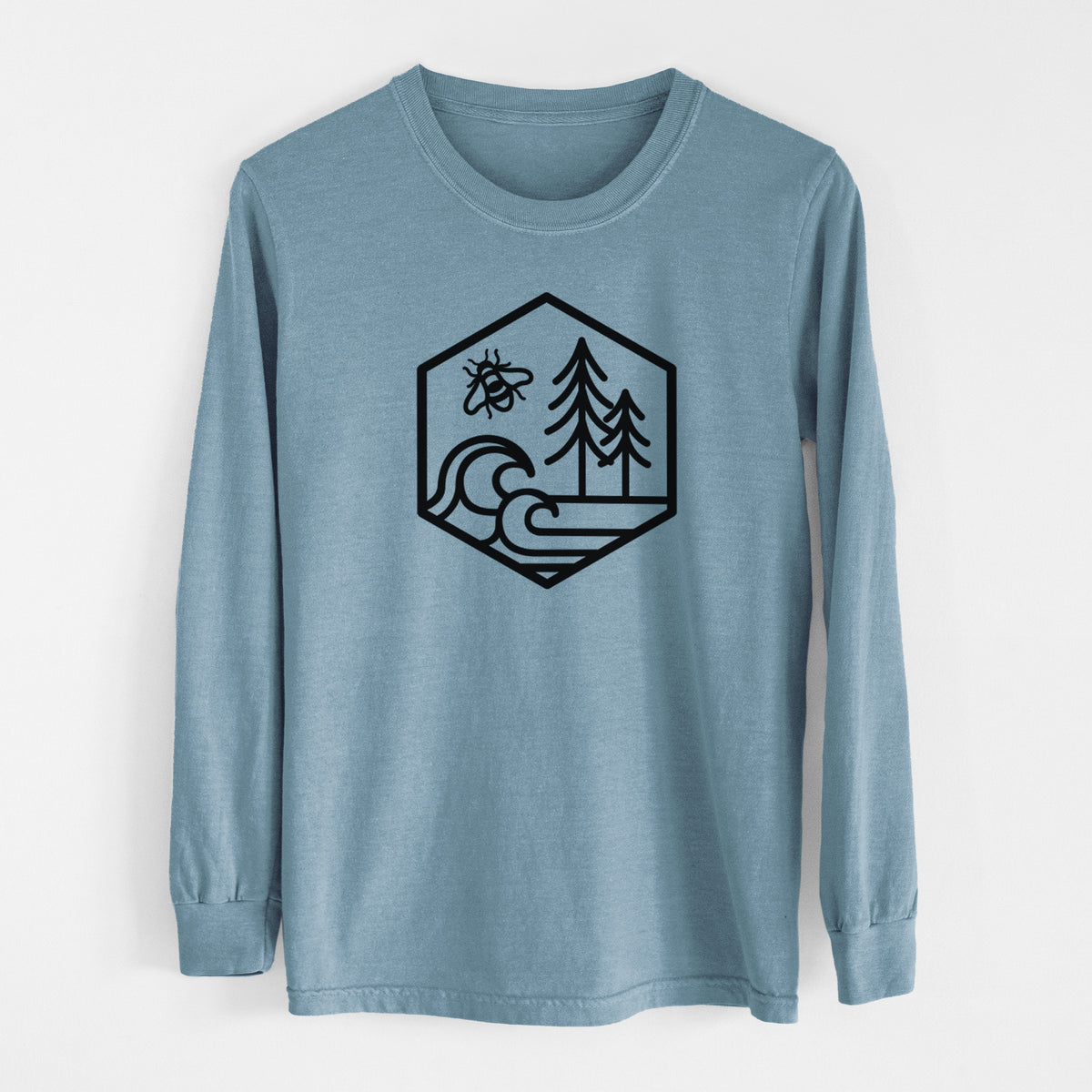 Steel blue Comfort Colors long sleeve shirt laid flat, printed with a black line art hexagon holding a bee, ocean waves and pine trees.