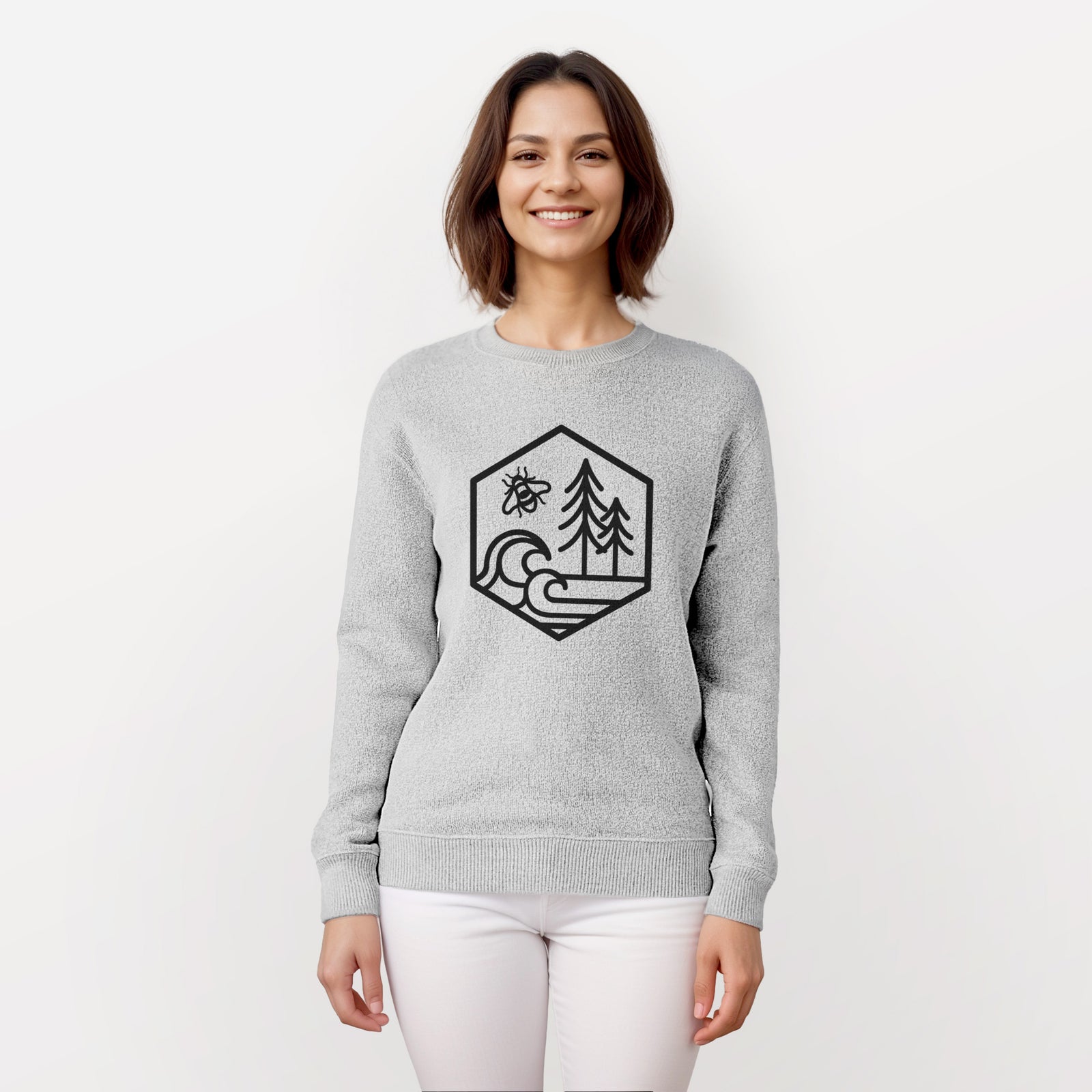 Salt and pepper knit sweatshirt laid flat, printed with a black line art hexagon holding a bee, ocean waves and pine trees.