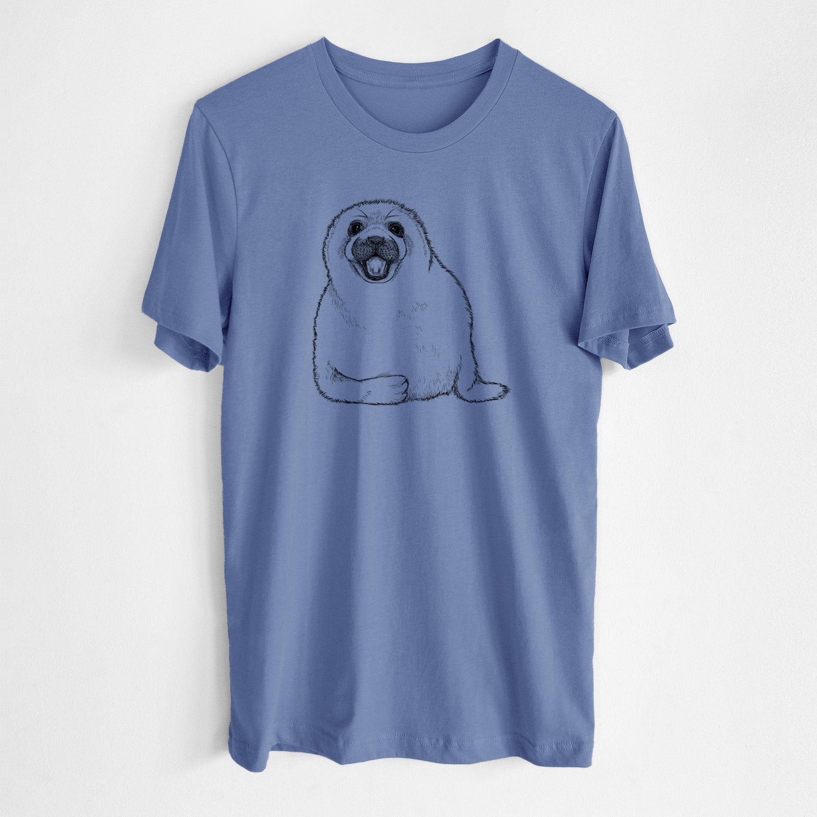 Blue bell lightweight cotton t-shirt laid flat, printed with a black ink illustration of a smiling harp seal pup lying down.