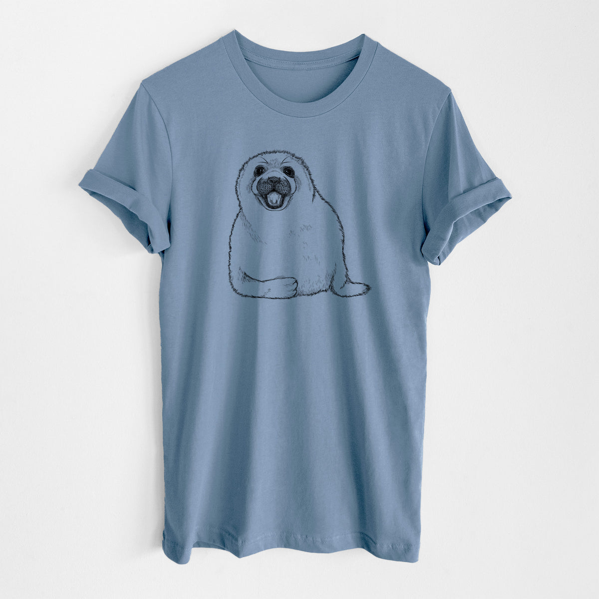 Steel blue lightweight cotton t-shirt laid flat, printed with a black ink illustration of a smiling harp seal pup lying down.
