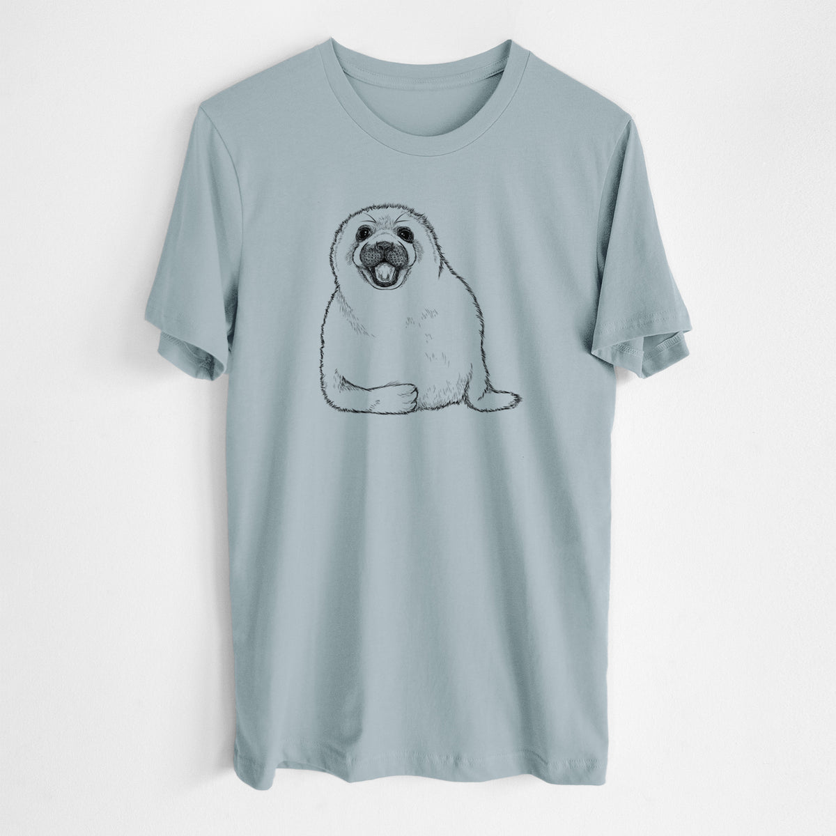 Vintage denim lightweight cotton t-shirt laid flat, printed with a black ink illustration of a smiling harp seal pup lying down.