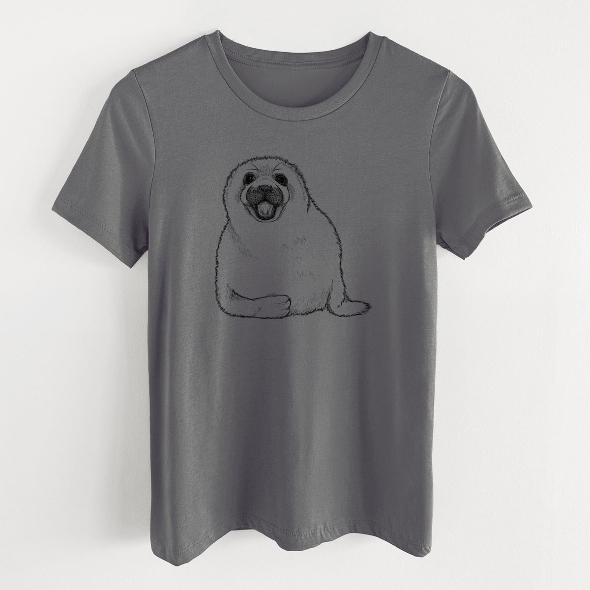 Asphalt women's relaxed fit cotton t-shirt laid flat, printed with a black ink illustration of a smiling harp seal pup lying down.