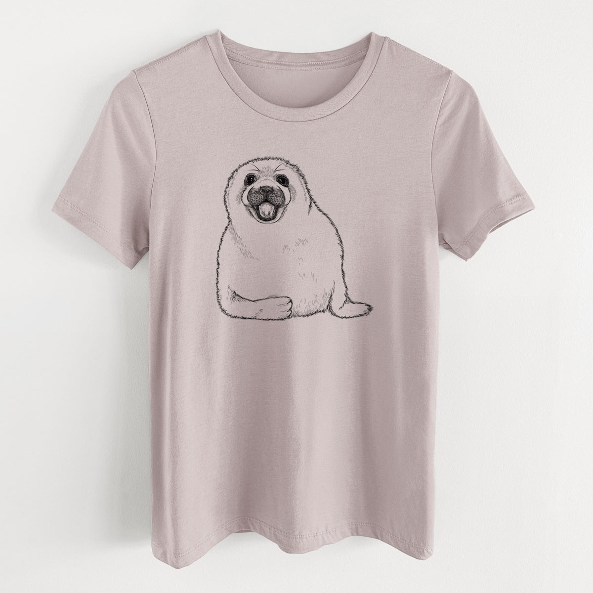 Pink gravel women's relaxed fit cotton t-shirt laid flat, printed with a black ink illustration of a smiling harp seal pup lying down.