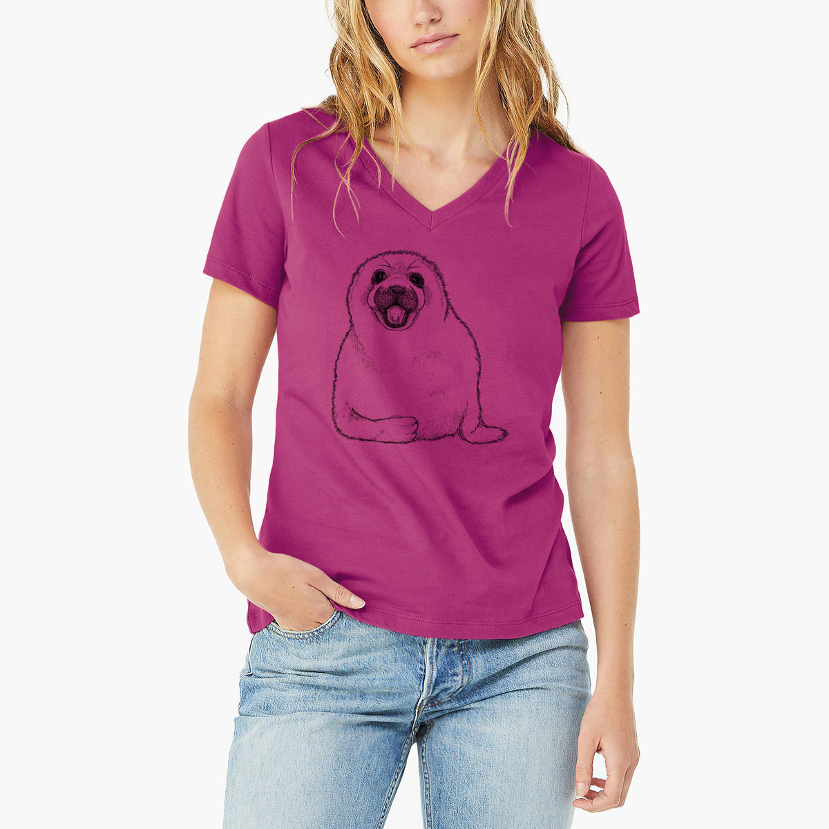 Woman wearing a berry pink women's relaxed fit cotton V-neck t-shirt printed with a black ink illustration of a smiling harp seal pup lying down.