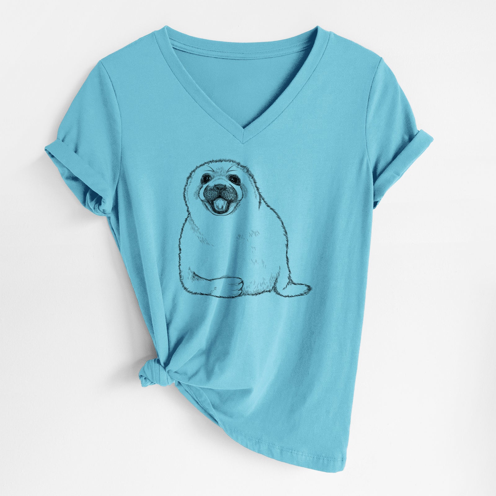 Turquoise women's relaxed fit cotton V-neck t-shirt laid flat, printed with a black ink illustration of a smiling harp seal pup lying down.