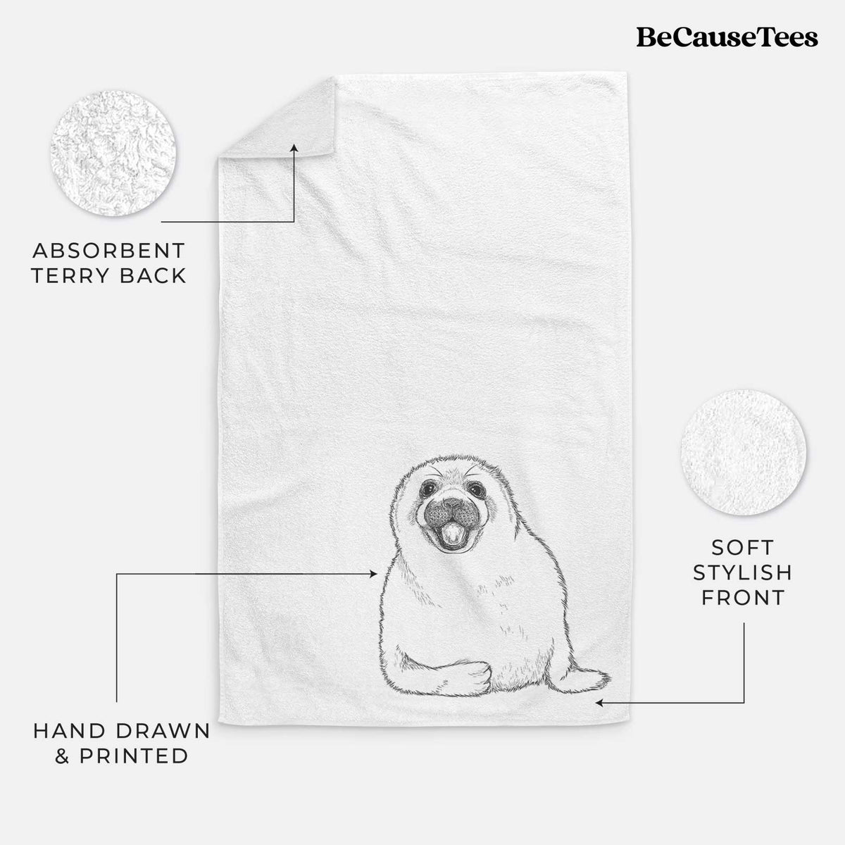 White hand towel printed with a black ink illustration of a smiling harp seal pup lying down.