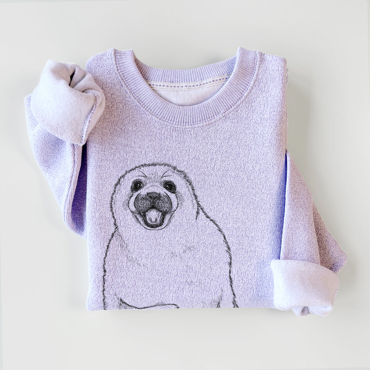 Ice purple knit sweatshirt printed with a black ink illustration of a smiling harp seal pup lying down, styled flat.