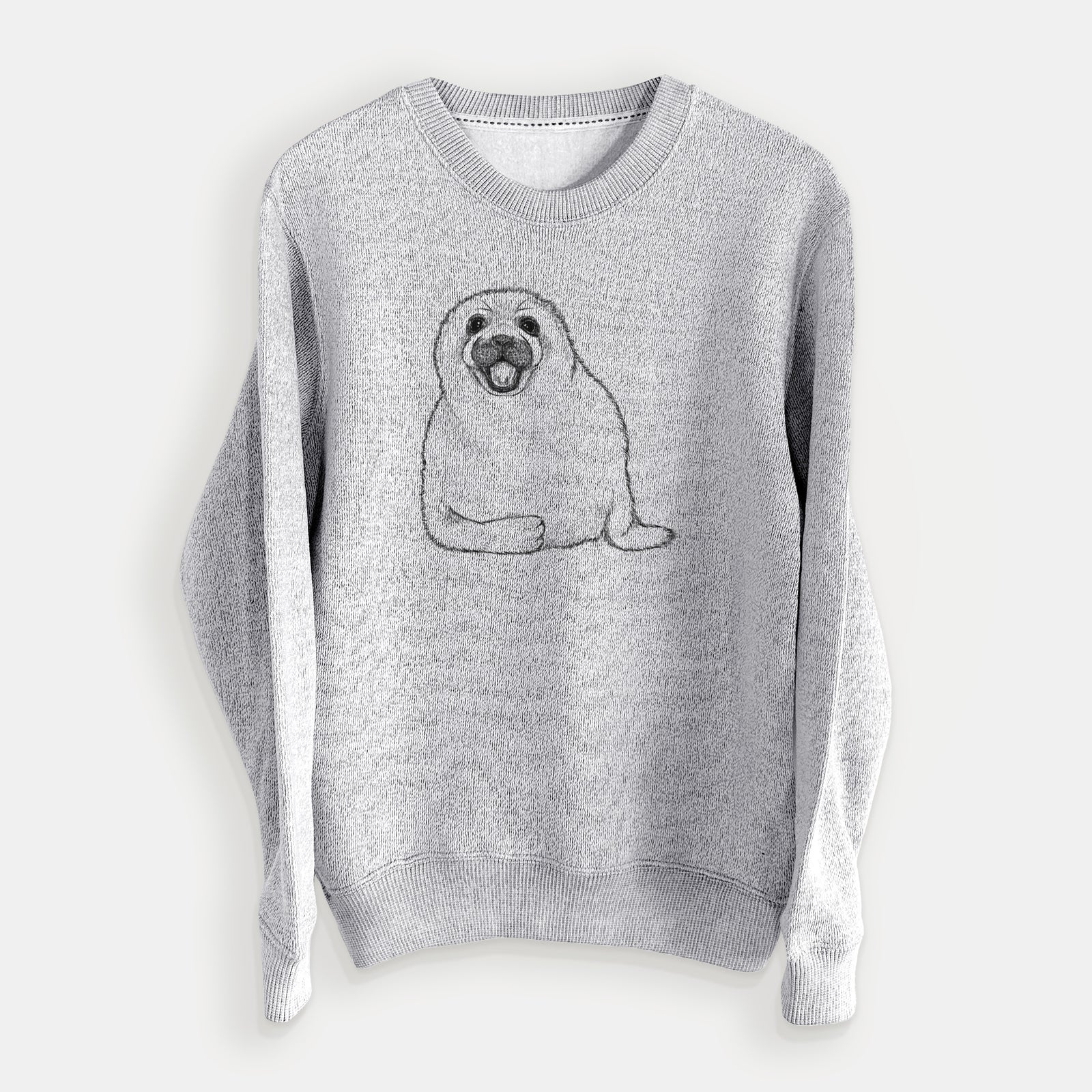 Salt and pepper knit sweatshirt laid flat, printed with a black ink illustration of a smiling harp seal pup lying down.