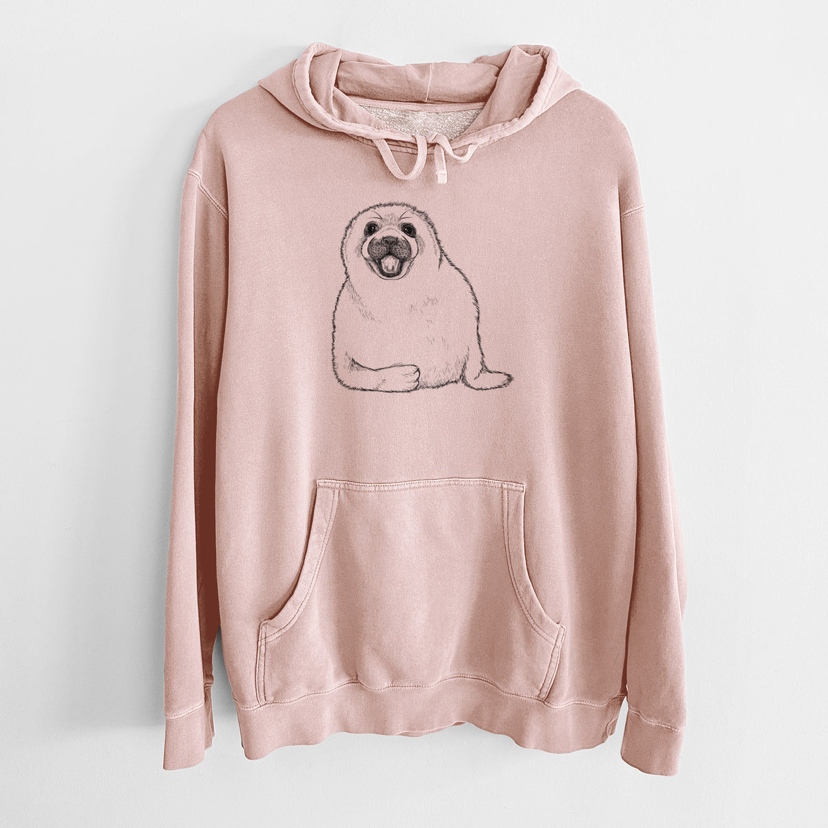 Dusty pink pigment dyed hoodie laid flat, printed with a black ink illustration of a smiling harp seal pup lying down.