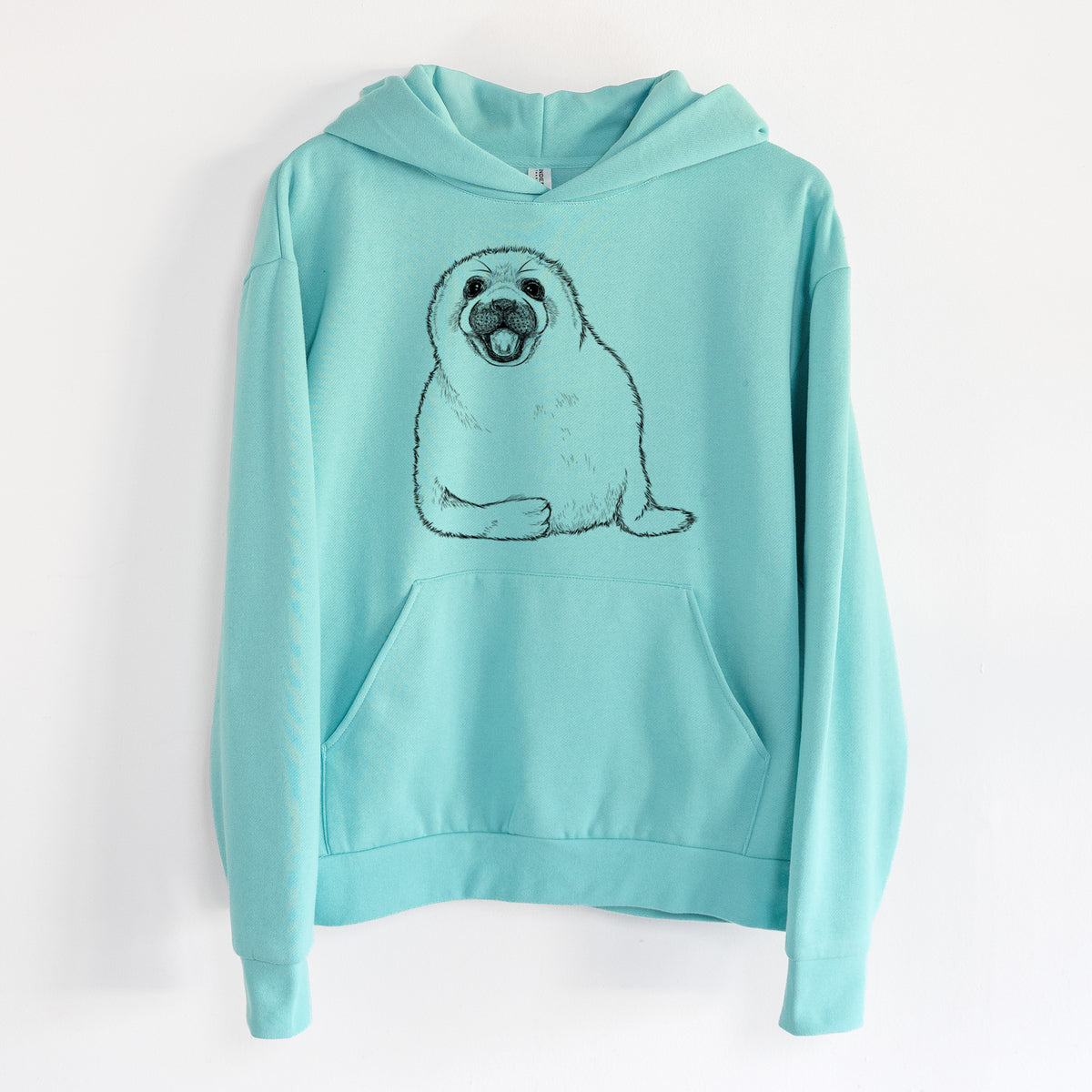 Harp Seal Pup - Pagophilus groenlandicus - Statement Midweight Hoodie in Seafoam, hanging on a white wall, with a front kangaroo pocket and no drawcords.