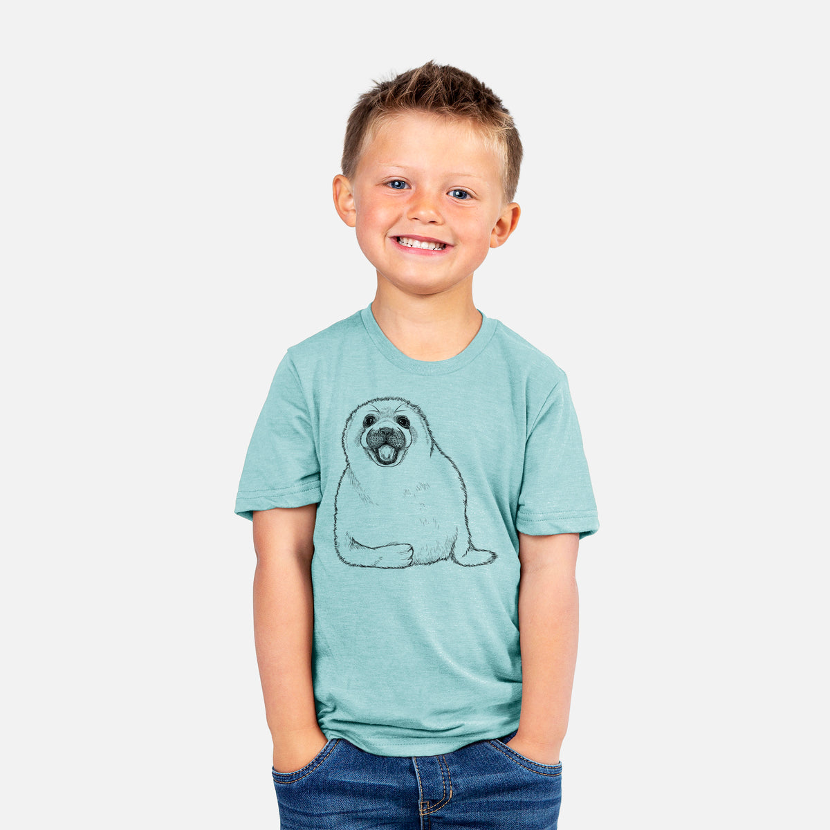 Smiling boy wearing a youth t-shirt printed with a black ink illustration of a smiling harp seal pup lying down.