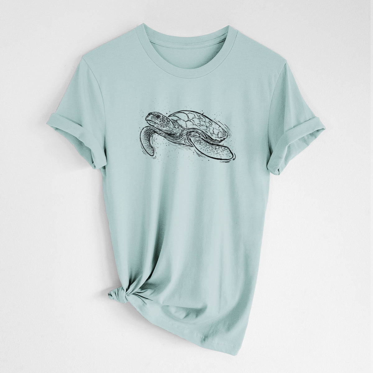 Dusty blue lightweight cotton t-shirt laid flat with the sleeves rolled, printed with a black ink illustration of a hawksbill sea turtle swimming, with a patterned shell.