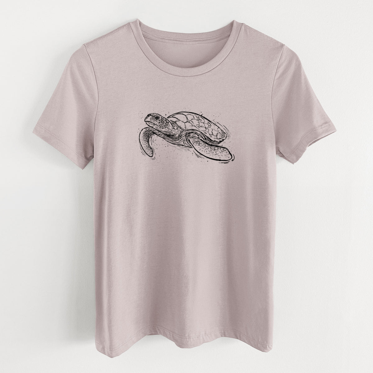 Pink gravel women's relaxed fit cotton t-shirt laid flat, printed with a black ink illustration of a hawksbill sea turtle swimming, with a patterned shell.