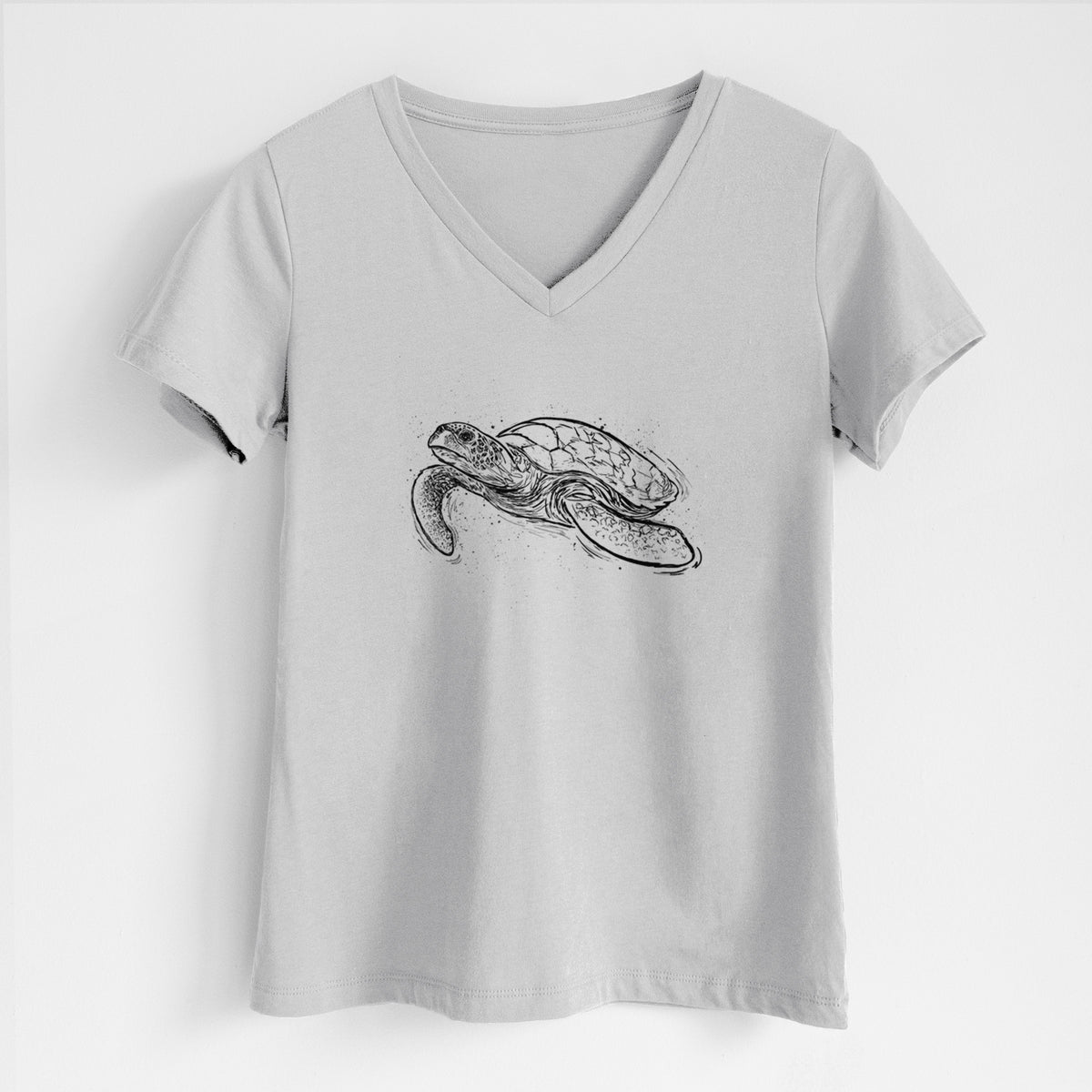 Lunar grey women's relaxed fit cotton V-neck t-shirt laid flat, printed with a black ink illustration of a hawksbill sea turtle swimming, with a patterned shell.