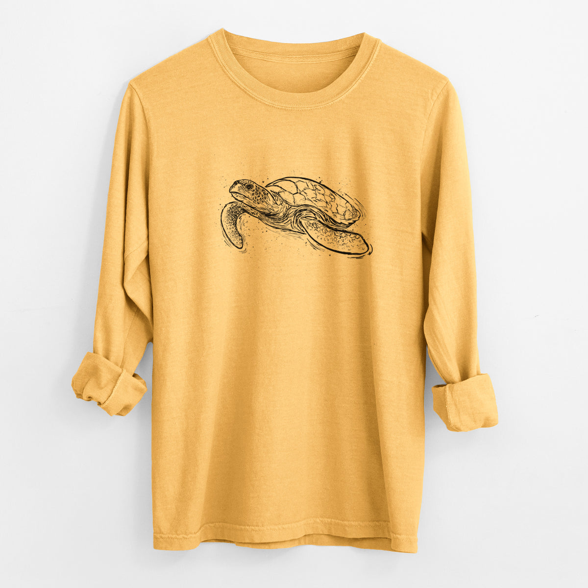 Golden wheat yellow Comfort Colors long sleeve shirt laid flat with the cuffs rolled, printed with a black ink illustration of a hawksbill sea turtle swimming, with a patterned shell.