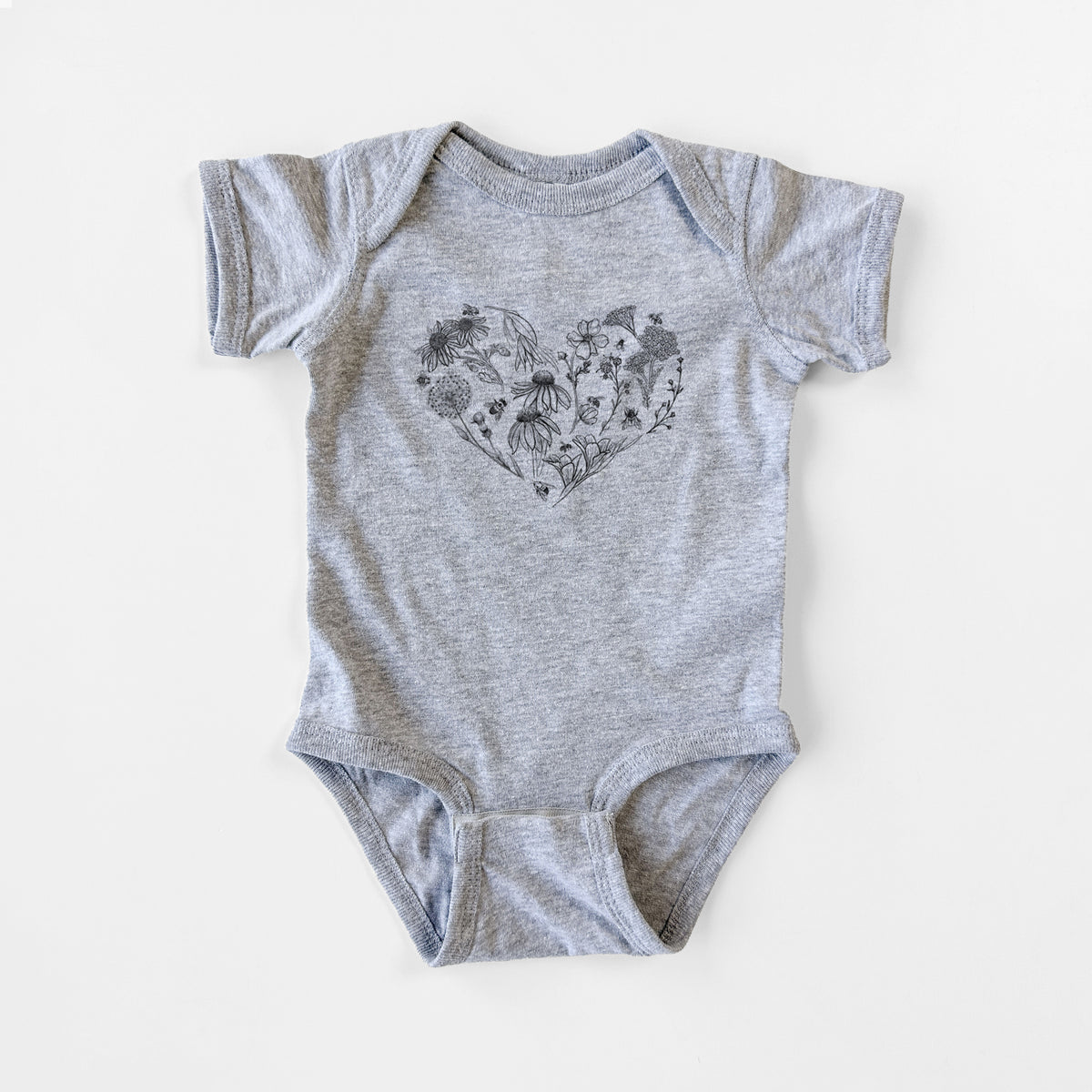 Grey baby bodysuit laid flat, printed with a heart shape filled with black ink flowers and bees.