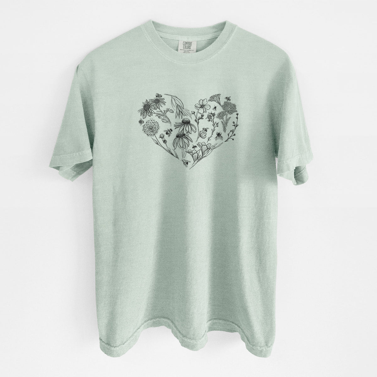 Bay green Comfort Colors t-shirt laid flat, printed with a heart shape filled with black ink flowers and bees.