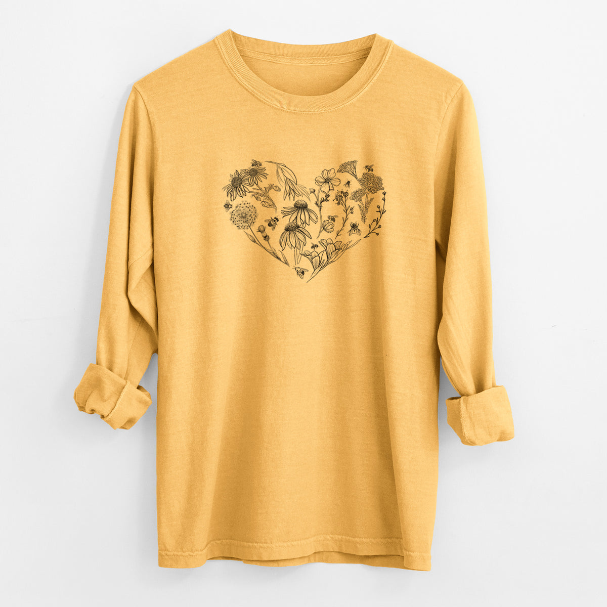 Golden wheat yellow Comfort Colors long sleeve shirt laid flat with the cuffs rolled, printed with a heart shape filled with black ink flowers and bees.