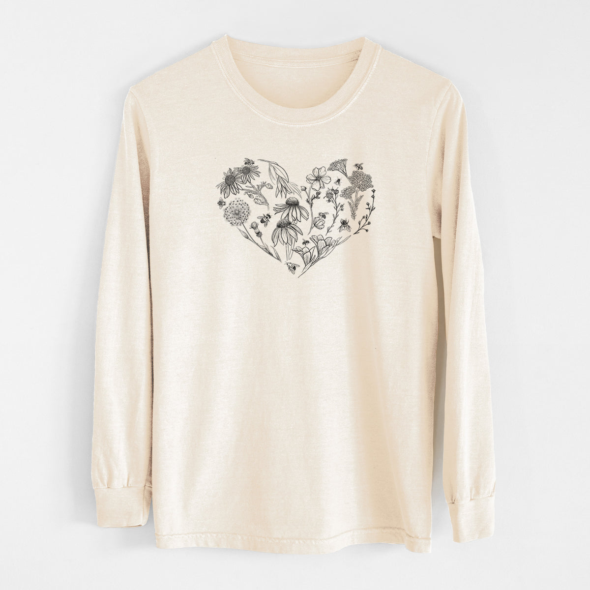 Ivory Comfort Colors long sleeve shirt laid flat, printed with a heart shape filled with black ink flowers and bees.