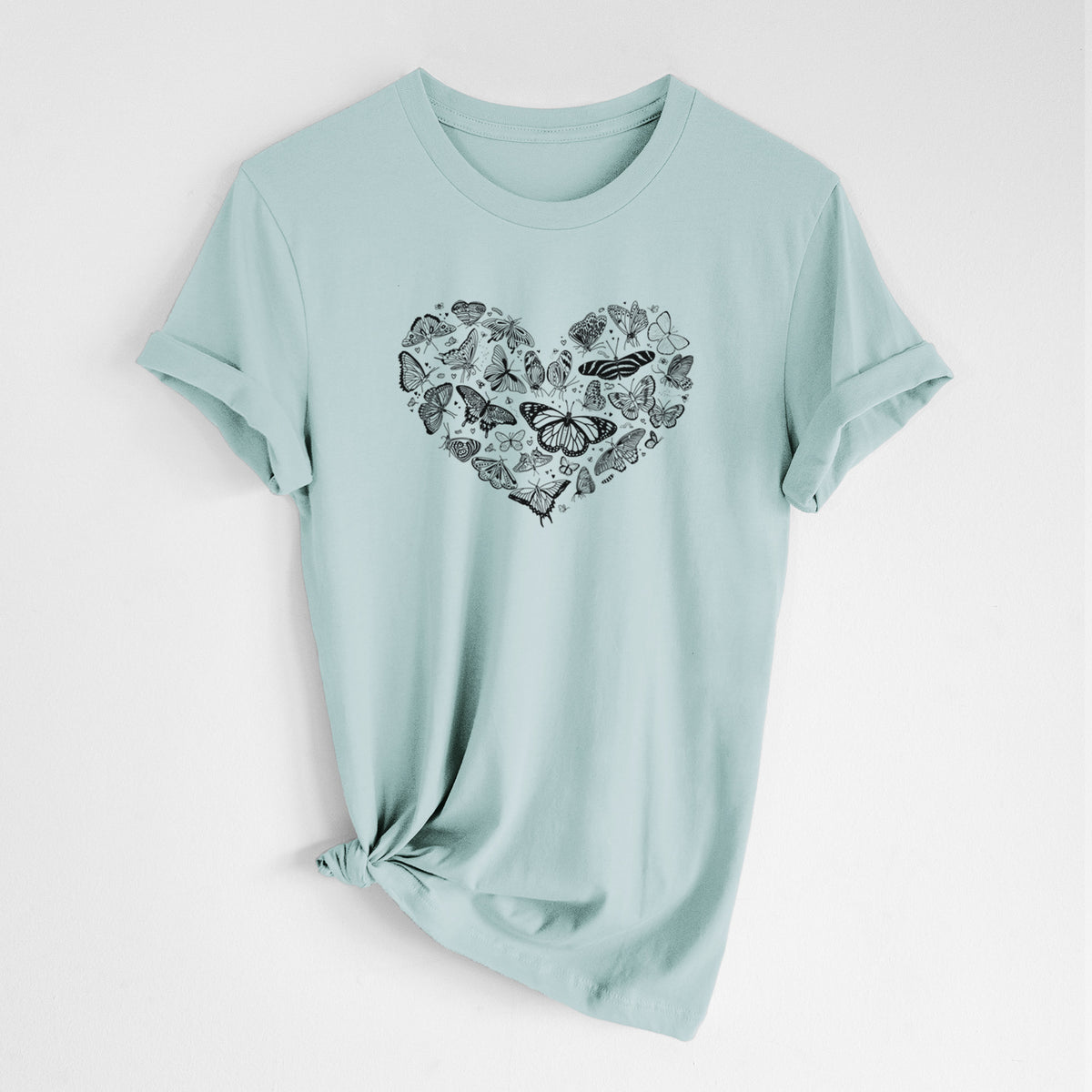 Dusty blue lightweight cotton t-shirt laid flat with the sleeves rolled, printed with a heart shape filled with small black ink butterflies and moths.