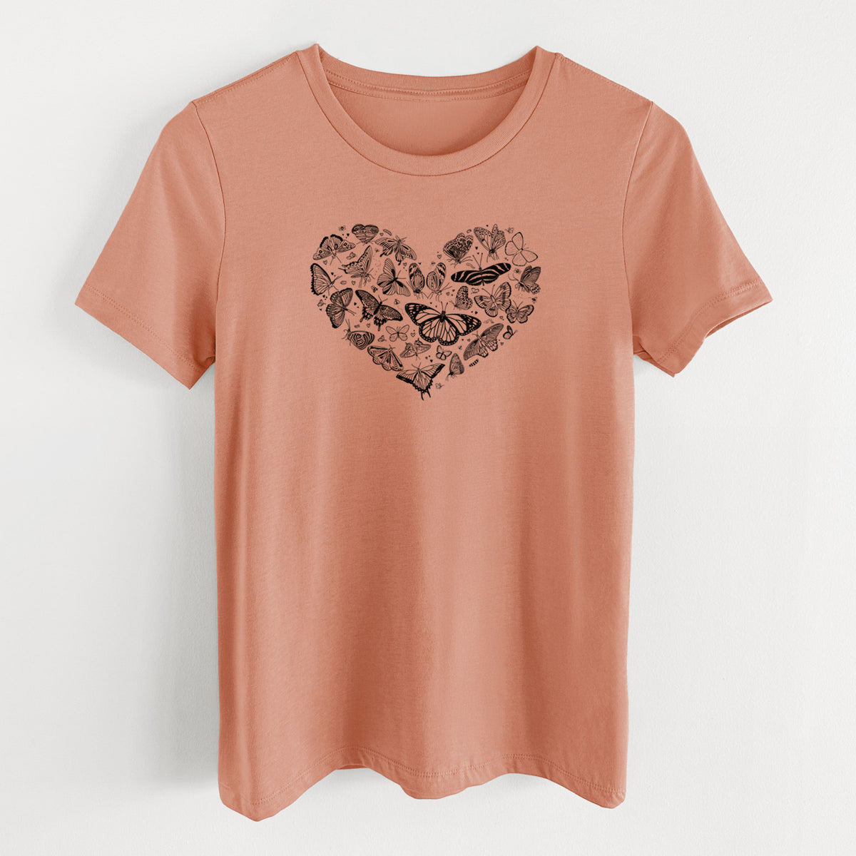 Terracotta orange women's relaxed fit cotton t-shirt laid flat, printed with a heart shape filled with small black ink butterflies and moths.