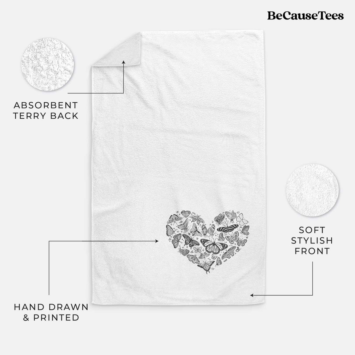White hand towel printed with a heart shape filled with small black ink butterflies and moths.