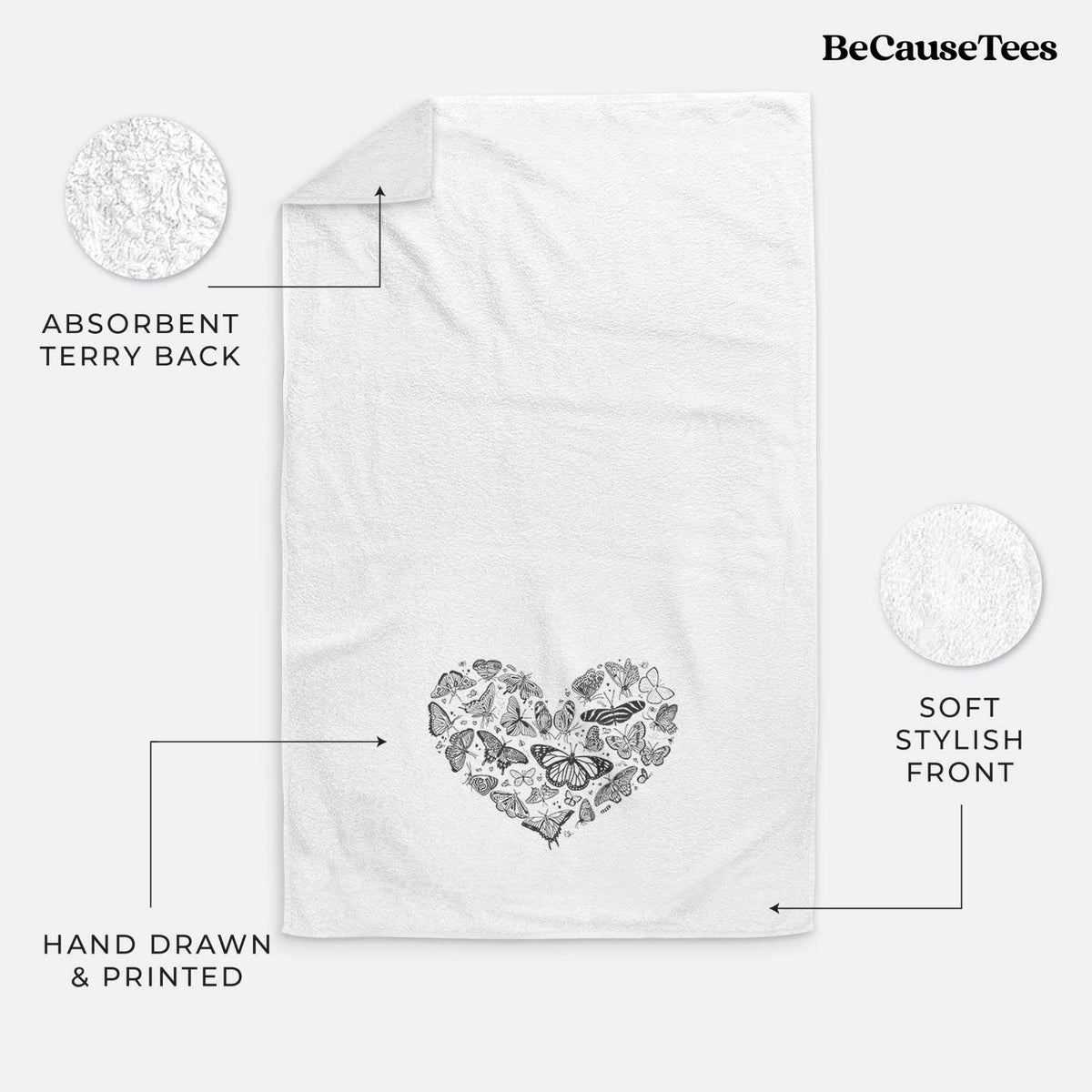 White hand towel printed with a heart shape filled with small black ink butterflies and moths.