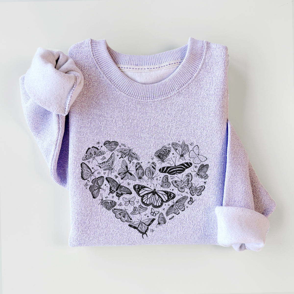 Ice purple knit sweatshirt printed with a heart shape filled with small black ink butterflies and moths, styled flat.