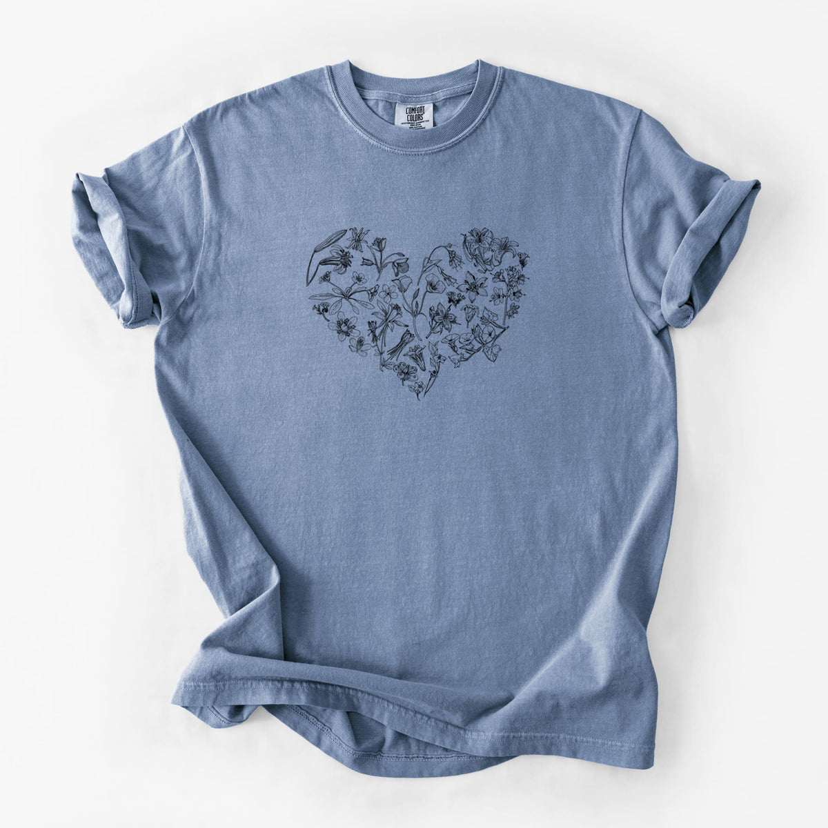 Blue jean Comfort Colors t-shirt laid flat, printed with a heart shape filled with black ink California mountain wildflowers.