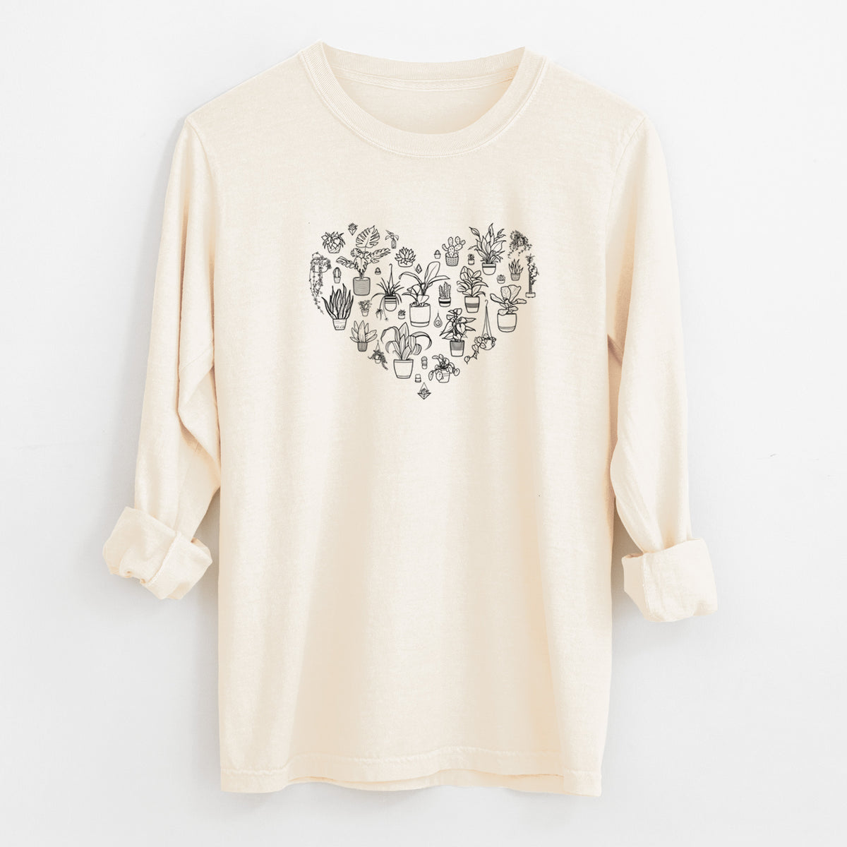 Ivory Comfort Colors long sleeve shirt laid flat with the cuffs rolled, printed with a heart shape filled with black ink potted houseplants.