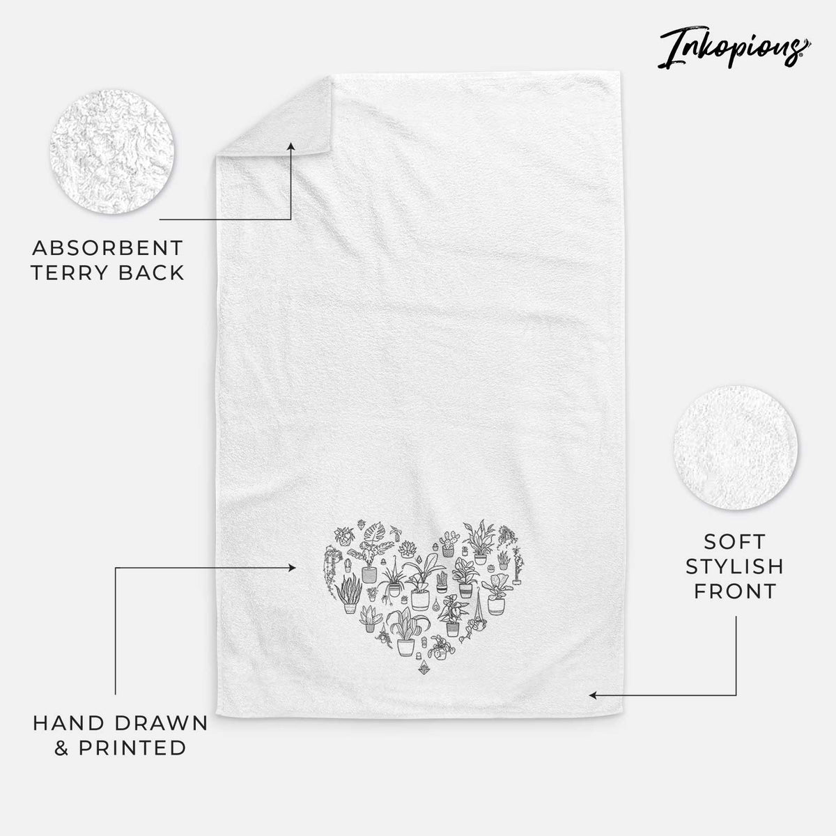 White hand towel printed with a heart shape filled with black ink potted houseplants.