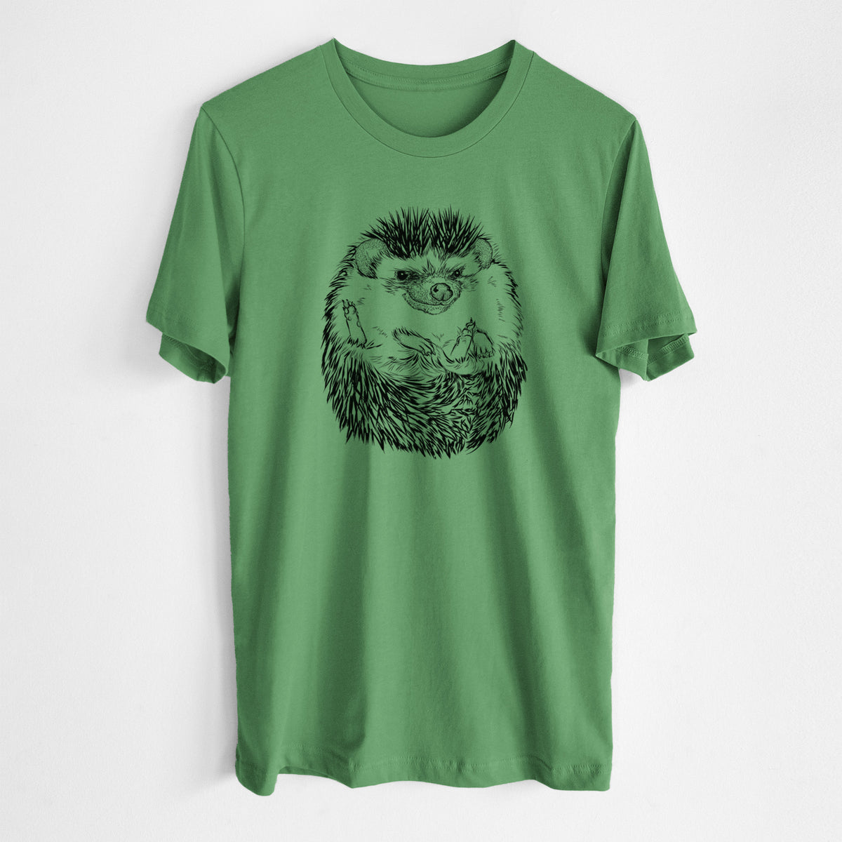 Leaf green lightweight cotton t-shirt laid flat, printed with a detailed black ink illustration of a hedgehog curled up and facing forward.