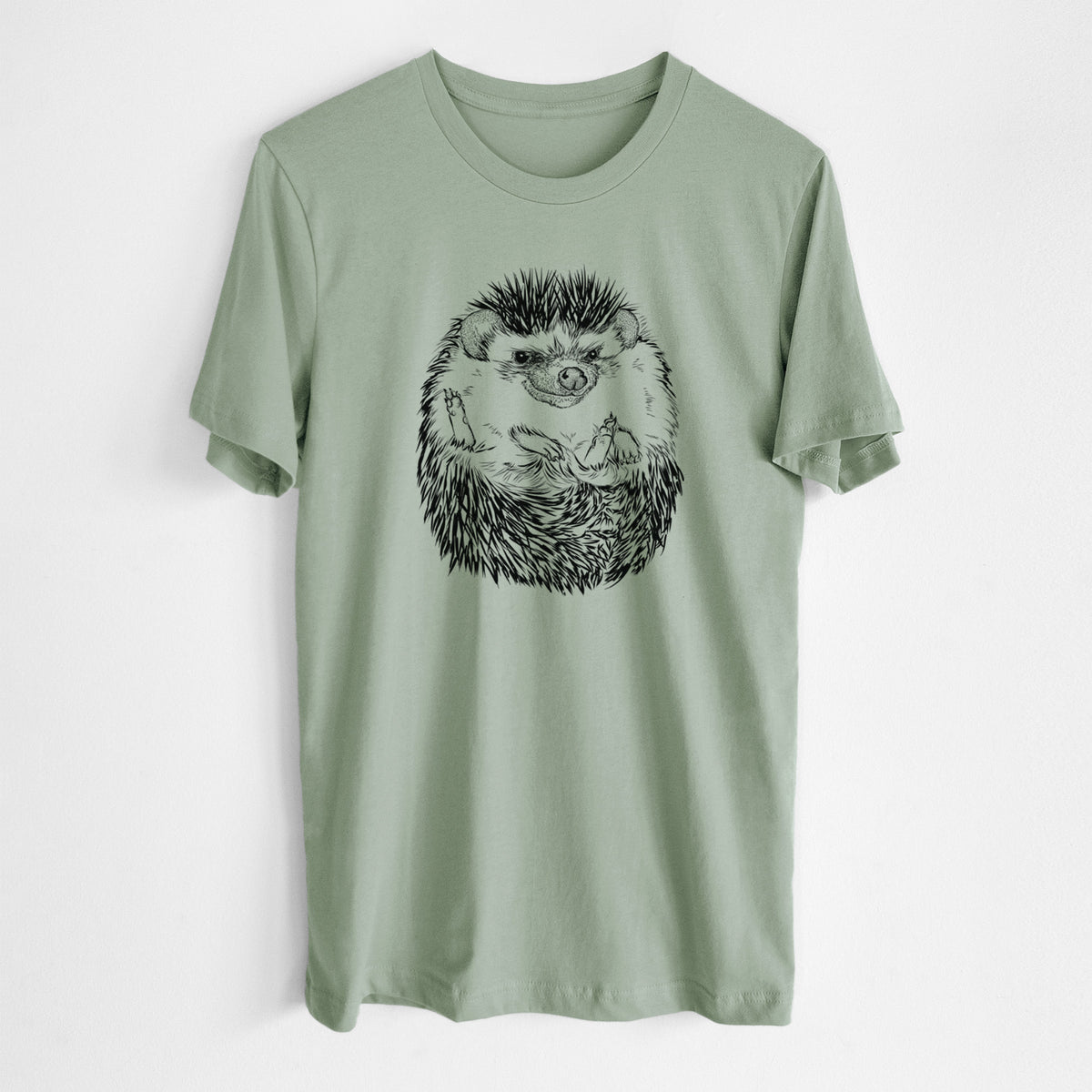 Sage green lightweight cotton t-shirt laid flat, printed with a detailed black ink illustration of a hedgehog curled up and facing forward.