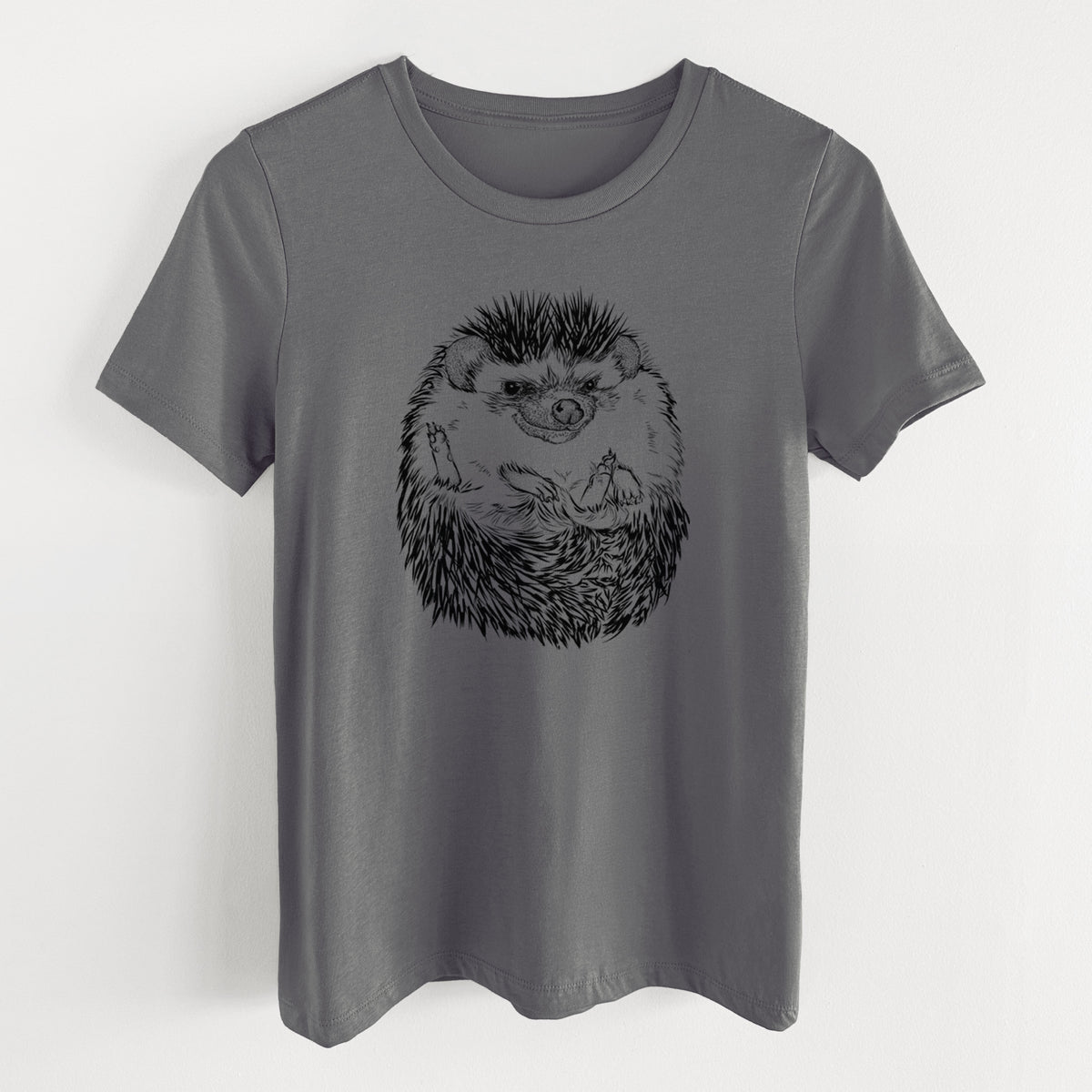 Asphalt women's relaxed fit cotton t-shirt laid flat, printed with a detailed black ink illustration of a hedgehog curled up and facing forward.