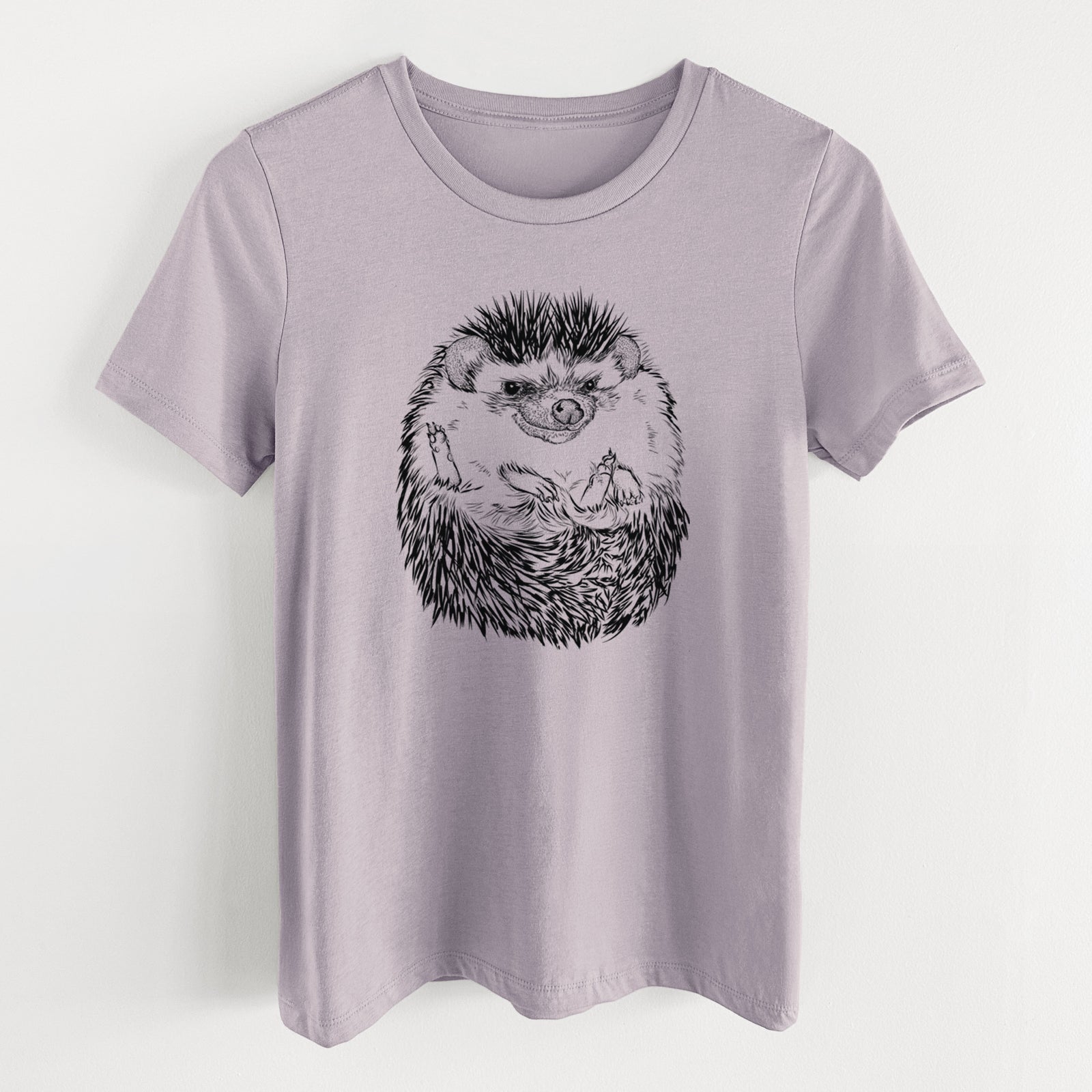 Light violet women's relaxed fit cotton t-shirt laid flat, printed with a detailed black ink illustration of a hedgehog curled up and facing forward.