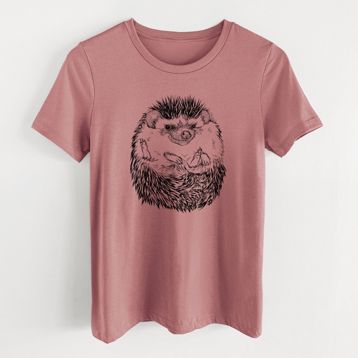 Mauve pink women's relaxed fit cotton t-shirt laid flat, printed with a detailed black ink illustration of a hedgehog curled up and facing forward.