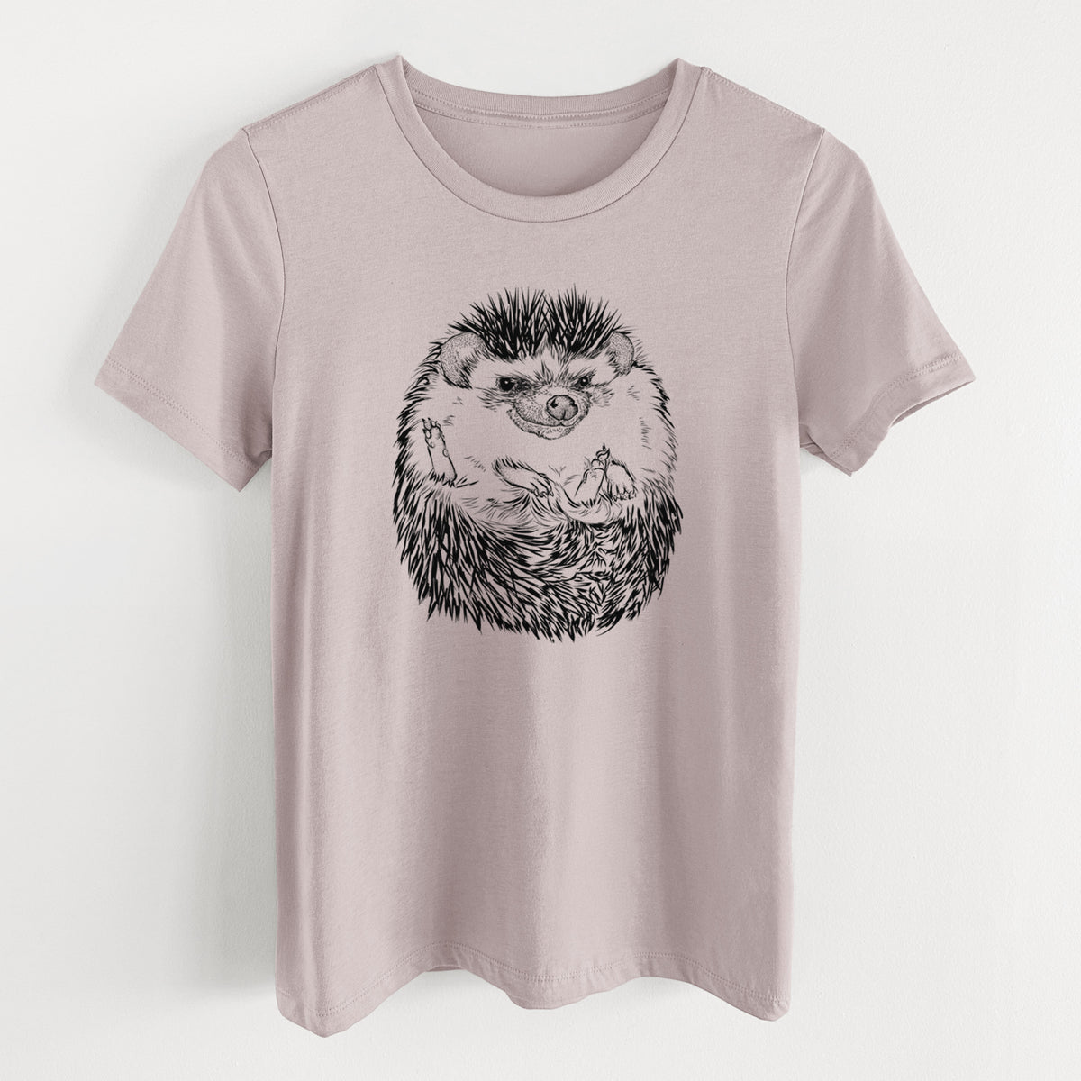 Pink gravel women's relaxed fit cotton t-shirt laid flat, printed with a detailed black ink illustration of a hedgehog curled up and facing forward.