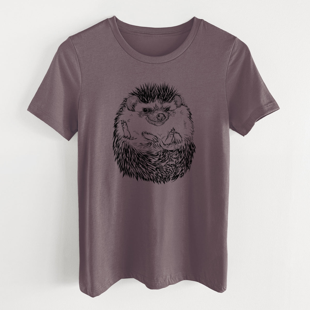 Purple storm women's relaxed fit cotton t-shirt laid flat, printed with a detailed black ink illustration of a hedgehog curled up and facing forward.