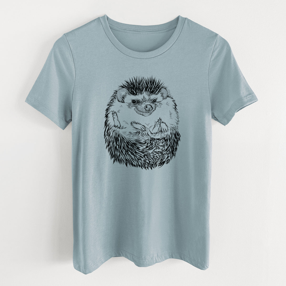 Vintage denim women's relaxed fit cotton t-shirt laid flat, printed with a detailed black ink illustration of a hedgehog curled up and facing forward.