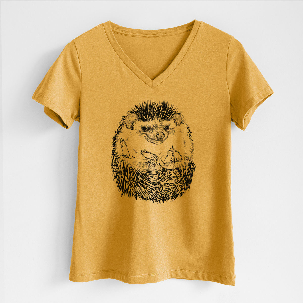 Honeycomb yellow women's relaxed fit cotton V-neck t-shirt laid flat, printed with a detailed black ink illustration of a hedgehog curled up and facing forward.